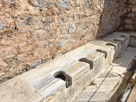 Ancient public Toilet bathroom seats on Ephesus , public toilets used in ancient times, sitting toilets side by side