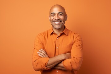 Portrait of smiling african american man in orange shirt on orange background