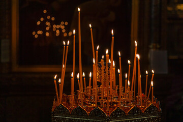 Lighted candles in a dark Orthodox church