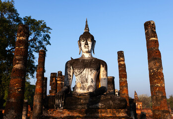 Wat Tra Phang Ngoen. Old sitting Buddha statue and temple ruins. Sukhothai Historical Park....