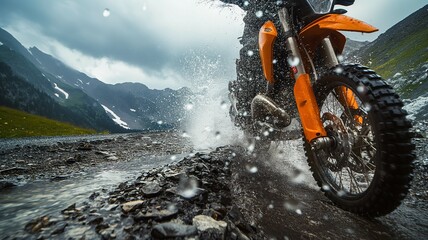 Rider navigating a wet rocky path on a bike - obrazy, fototapety, plakaty