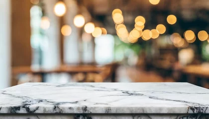Fotobehang empty white marble stone table top on blurred with bokeh cafe and restaurent interior background can be used for display or montage your products © Heaven