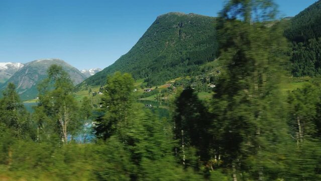 Ride along the scenic shore of the fjord in Norway, view from the car window