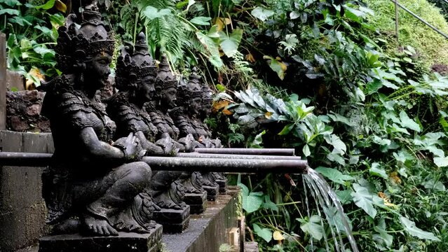 Tripod shot of running to pool for pilgrims water nearby Air Terjun Jagasatru waterfall. Bali, Indonesia.
