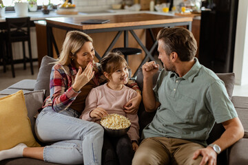 Cozy family time: sharing laughter and popcorn on a casual evening