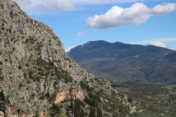 Fototapeta na wymiar Majestic Embrace: Delphi Enveloped by Mountain Majesty