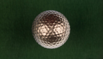 golden golf ball isolated on green background