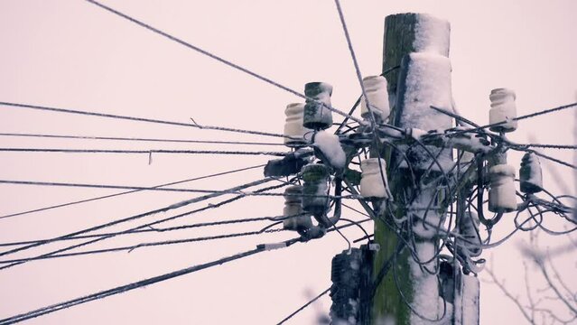 Telegraph pole covered in winter snow 