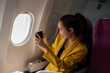 Woman Using Smartphone on Airplane