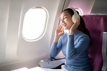 Smiling Woman with Headphones on Airplane