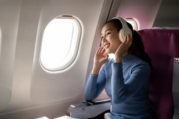 Smiling Woman with Headphones on Airplane