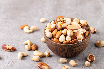 Healthy mix nuts on wooden background. Almonds, hazelnuts, cashews, peanuts, pistachios, Brazil nuts