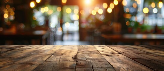 Empty wooden table top with a blurred coffee shop and restaurant interior background, suitable for showcasing or combining your products.