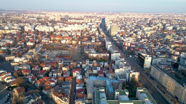 Aerial drone shot of Piața Victoriei in Bucharest - Romania. High angle footage of the infamous square in the capital of Romania with Victoria Palace and the Secretariat General of the government.
