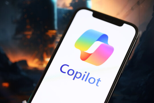 KYIV, UKRAINE - MARCH 17, 2024 Microsoft Copilot logo on iPhone display screen with background of artificial intelligence futuristic ai generated image close up