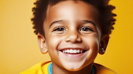 Face of happy african boy on yellow background, close-up