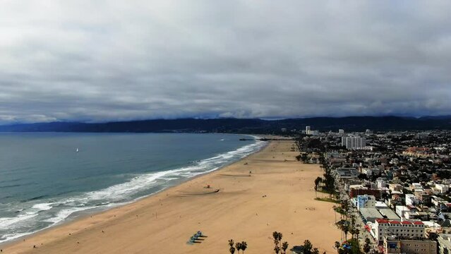 Aerial Forward Time Lapse Scenic View Of Beach By Town Under Cloudy Sky - Los Angeles, California