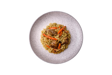 Delicious pilaf with vegetables, salt, spices and herbs in a ceramic plate