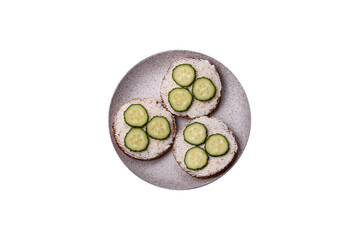 Delicious vegetarian sandwich with grilled toast, cream cheese, cucumbers and seeds - 767324727