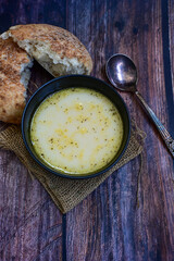 Home made chicken soup with noodles ,parsley and vegetables in white bowl . Healty soup