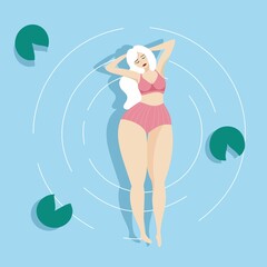 A girl in a pink swimsuit swims in the sea.