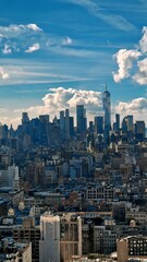 New York city skyline during day with view of Manhattan and World Trade Center in blue sky with...