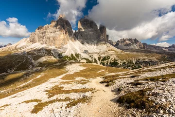 Outdoor kussens Rocky footpaths below the monumental peak of Tre Cime with the cloudy blue sky © Simona_Mach