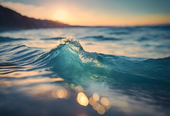 Close-up of a small wave cresting with sunset light in the background, creating a tranquil ocean...