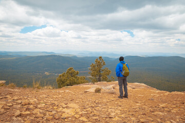 Solo traveler in the mountains. Man with a backpack enjoying the mountains view. Payson, Arizona