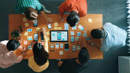 Top view of developer team working together to write idea about Ux Ui design on whiteboard. Smart...
