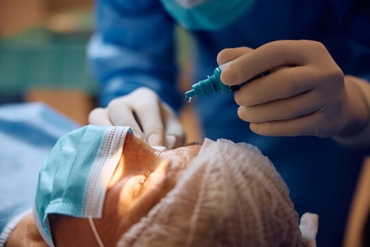 Close up of patient receiving anesthetic eye drops before surgery.