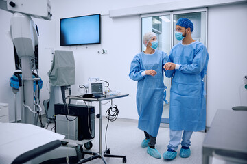 Surgical technician assisting mature female patient to get in the operating room at ophthalmology...