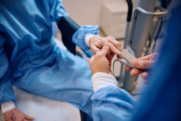 Close up of mature patient getting pulse oximeter while undergoing  surgery at eye clinic.