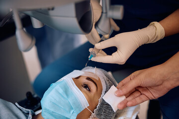 Young woman getting prepared for laser surgery at eye clinic.