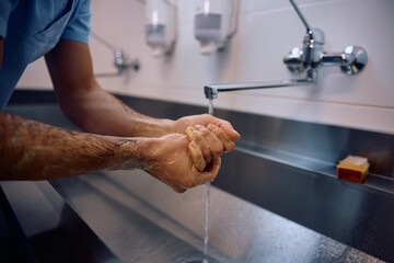 Close up of surgeon washing his hands before getting into operating room.