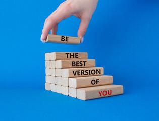 Be the best version of you symbol. Concept words Be the best version of you on wooden blocks. Businessman hand. Beautiful blue background. Business concept. Copy space.