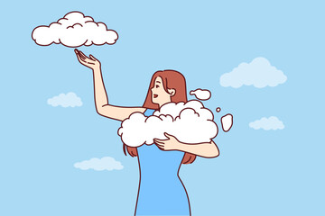 Woman takes clouds from sky, enjoying clear weather and fresh air available thanks to clean environment. Young girl seeing wonderful dream about opportunity to hold clouds with firmament in hands - 767374568