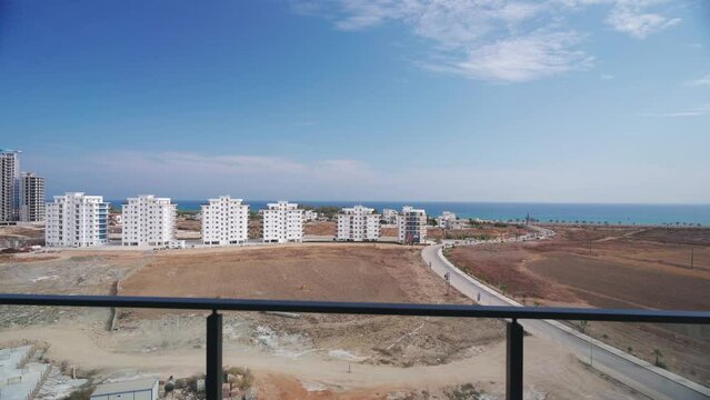 Luxurious beachfront apartment tour from interior to balcony showcasing panoramic sea views, suitable for property investment, in potential vacation hotspot.