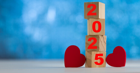 New Year text 2025 inscribed on the dice tower with two hearts. Concept of special occasions in the new year. 