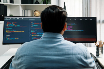 Concentrating in smart IT developer working software development coding on two pc screen, creating...