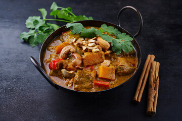 Traditional Indian vegetarian curry stew with sweet potatoes, paprika and eggplant served as...