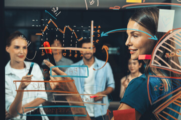 Group of smart diverse businesspeople brainstorming business strategy. Young female leader sharing, explaining, designing business idea at night office. Business planing, Working together. Tracery.