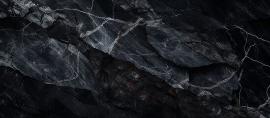 A detailed shot capturing the intricate pattern of a black marble texture, resembling a mountain range seen from the sky
