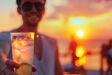 Sierkussen Refreshing Summer Drink in Focus Against Sunset Beach Backdrop Banner © Алинка Пад