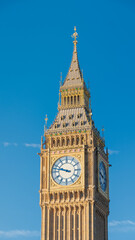 Close-up of the clock on the tower of London known as Big Ben. The roof decorated with the symbols...