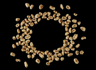 Puffed wheat cereal flakes with honey isolated on black, top view	 - 767396323