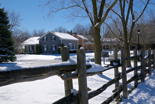 A Canadian village with wooden post fences in the foreground.
