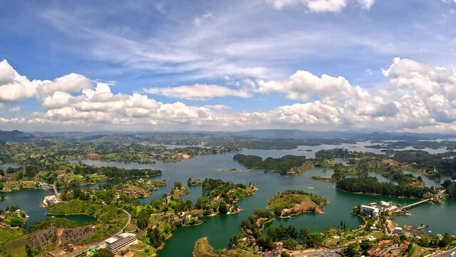 timelapse from the top of the Pe&ntilde;ol de Guatap&eacute; stone or 'piedra del pe&ntilde;ol' in Antioquia Colombia, with lakes, clouds, mountains and boats