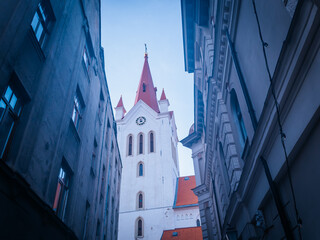 Cesis church tower between two houses