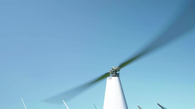 Main rotor blades of helicopter rotating against blue sky background, helicopter blades in motion, powerful engine of aircraft keep moving rotor blades while taking off or landing